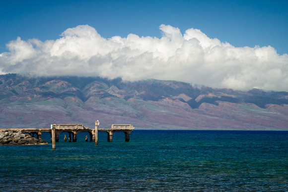 Pier on ocean in Maui, Hawaii, with view of Lanai in the background.